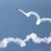 Small plane jetting into the sky. Article title: S&P 500 and NASDAQ Hit Record Highs Amidst Mixed Economic Signals