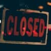 Close sign. Article title: Markets Rise as Government Shutdown Drags On