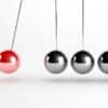 Newton Pendulum. Article title: Markets Swing as Tariffs Reignite Trade War Fears